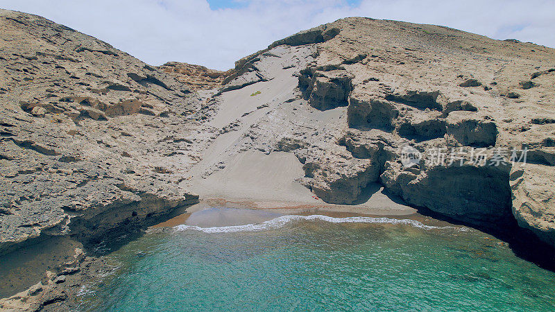 Aerial view of the hidden cove beach "La Rajita" at the natural reserve of "Monta?a Pelada" in Tenerife (Canary Islands). Drone shot